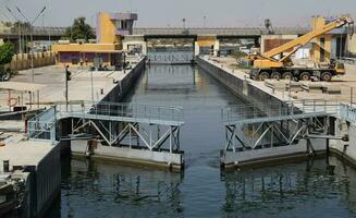 Cairo, Egypt, March 18, 2023 The Esna Lock. Device for lifting or lowering boats between waters of different depths of the Nile River to continue navigating. photo