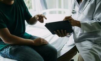 Doctor telling to patient woman the results of her medical tests. Doctor showing medical records to cancer patient in hospital ward. Senior doctor explaint the side effects of the intervention. photo