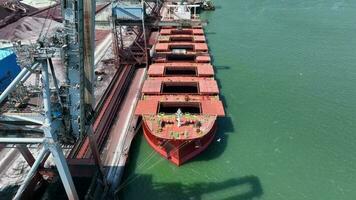 Cranes Unloading Commodities From a Bulk Carrier Ship at Port video