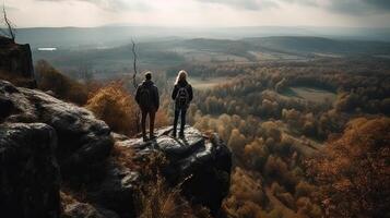 A man and a lady in traveler hardware are standing on a shake and respecting the all encompassing see. Creative resource, photo