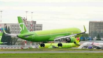 NOVOSIBIRSK, RUSSIAN FEDERATION JULY 15, 2022 - Airbus A321 of S7 Airlines landing and braking. Flight arrival, touchdown. Footage of a passenger jet plane flies, side view. video