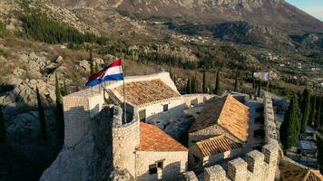 Aerial drone view of Croatian flag in the medieval fortress Sokol Grad. National monument. Historical visits. Vacations and holidays. Cultural place of interest. video