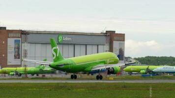 NOVOSIBIRSK, RUSSIAN FEDERATION JULY 15, 2022 - Plane Airbus A320, RA 73420 of S7 Airlines landing, side view. Airplane flies, slow motion. Tourism and travel concept video