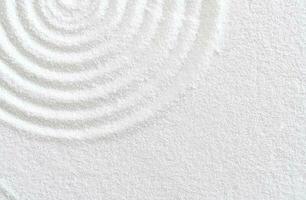 Sand texture with simple spiritual patterns,Japanese Zen Garden with concentric circles and parallel lines on  white sandy surface background,Harmony,Meditation,Zen like concept photo