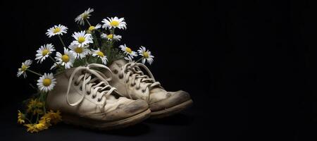 , Old boot with meadow spring flowers, handmade shoe planter. Environmental activism concept photo