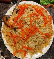 Kabuli pulao in white plate,Afghanistani rice in white plate with metal spoon photo
