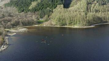 Canoeists on a Lake Surrounded by Forests and Mountains video