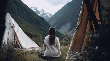 Travel. back see Youthful woman voyages through the mountains glamping, tents,waterfalls of wild nature. photo