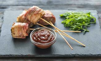 Bacon-wrapped beef skewers stuffed with mozzarella photo