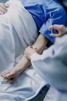 Doctor telling to patient woman the results of her medical tests. Doctor showing medical records to cancer patient in hospital ward. Senior doctor explaint the side effects of the intervention. photo