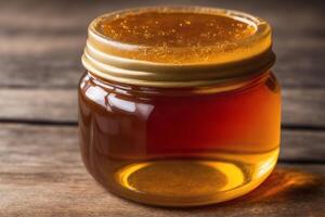 Honey in a glass jar on a wooden background. Selective focus. healthy food concept. photo