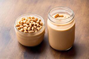 Peanut butter in a glass jar with peanuts on a wooden background. healthy food concept. photo