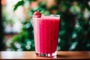 Fresh strawberry smoothie in a glass on a wooden table., closeup. Healthy food concept. photo