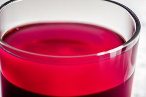 Cranberry juice in a glass on a wooden table, selective focus. Healthy food concept. photo