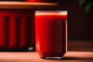 Fresh Tomato juice in a glass on a wooden background, closeup. Healthy food concept. photo