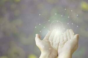 two hand of young  man open with blub  light of idea and polygon of technology, sketch light bulb on blur background photo