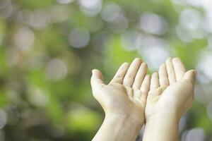 two hand open closeup need help or hope receiving empty and copy space on green blur bokeh background photo