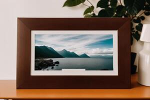 Photo frame on the wooden table. Blank wooden photo frame. Mock up.