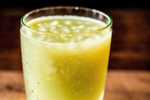 Cucumber smoothie in a glass on a black background. Green smoothie with lime and mint. Healthy food concept. photo