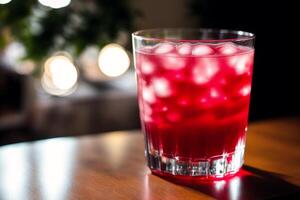 Cranberry juice in a glass on a wooden table, selective focus. Healthy food concept. photo