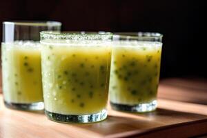 Cucumber smoothie in a glass on a black background. Green smoothie with lime and mint. Healthy food concept. photo