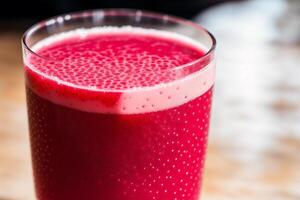 Fresh strawberry smoothie in a glass on a wooden table., closeup. Healthy food concept. photo