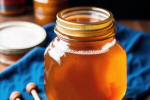 Honey in a glass jar on a wooden background. Selective focus. healthy food concept. photo