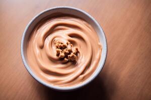 Roasted peanuts in white bowl on wooden background. Close up. photo