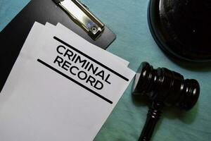 Criminal Record text on Document and gavel isolated on office desk. photo