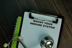 Boost Your Immune System write on a paperwork isolated on office desk. photo