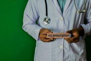 doctor standing on Green background. Hold the My Prescription paper text. Medical and healthcare concept. photo