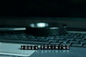 Forex Training text wooden blocks in laptop background. Business and technology concept photo