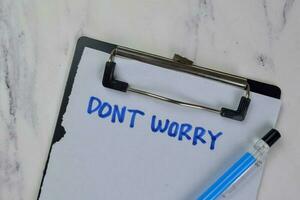 Don't Worry write on a paperwork isolated on Wooden Table. medical concept photo