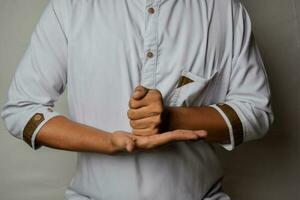 Close up Asian man shows hand gestures it means HELP isolated on white background. American sign language photo