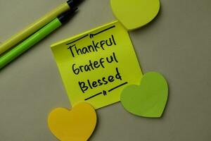 Thankful, Grateful, Blessed write on sticky notes isolated on office desk. photo