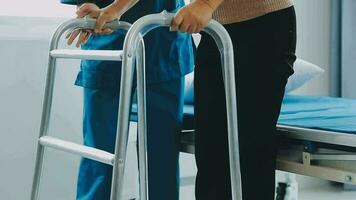 young asian physical therapist working with senior woman on walking with a walker video