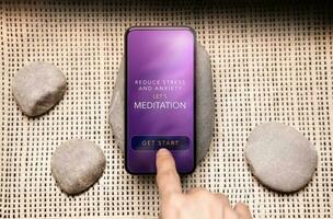 Mental Health Concept. Person Using Tech to Healing and Practicing Mind. Self Care and Soothing Life. Meditation App show on Mobile Phone. Scene as Zen. Top View photo