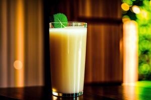 Glass of fresh mango juice on wooden table, closeup. Healthy food concept. photo