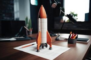 Successful startup concept. Launching rocket on office table. photo