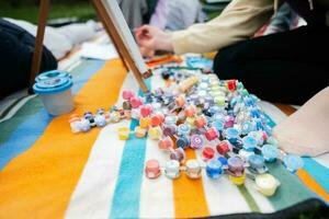 Drawing set outdoor on picnic blanket painting at garden spring park, relaxation. photo