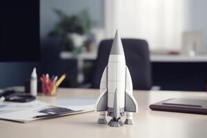Successful startup concept. Launching rocket on office table. photo