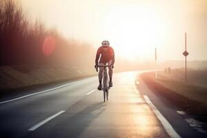 Professional cyclist in protective helmet trains on road. photo