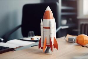 Successful startup concept. Launching rocket on office table. photo