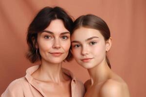 Mother and daughter portrait on pink background. photo