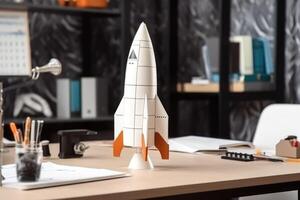 Successful startup concept. Launching rocket on office table. photo