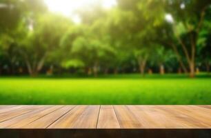 Empty wooden table with blurred natural green background. photo