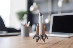 Successful startup concept. Launching rocket on office table. photo