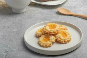 Orange cookies on a white plate photo