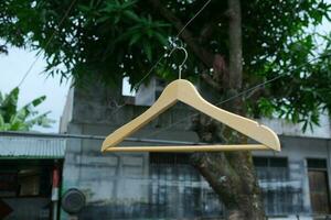 Photo of a wooden clothes hanger on a hanger