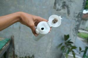 photo of a white drinking bowl held in hand